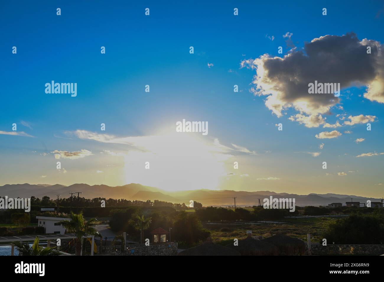 the sun sets behind the mountains in Cyprus Stock Photo