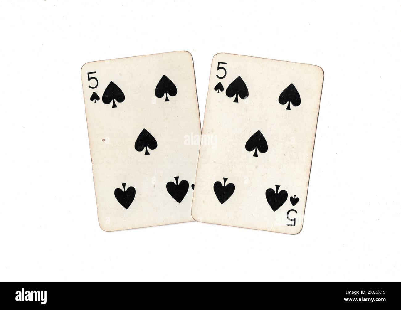 A pair of vintage five of spades playing cards on a white background ...