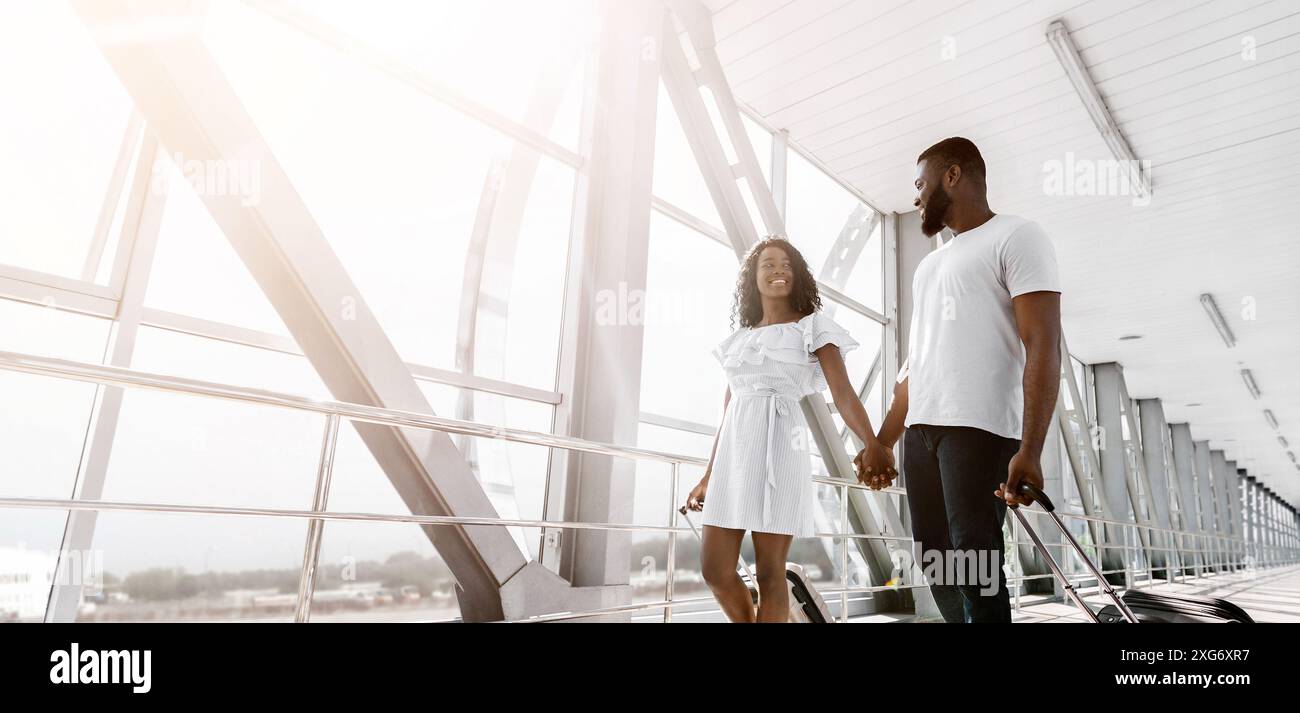 Happy African American Couple Walking Through Airport Terminal Stock ...