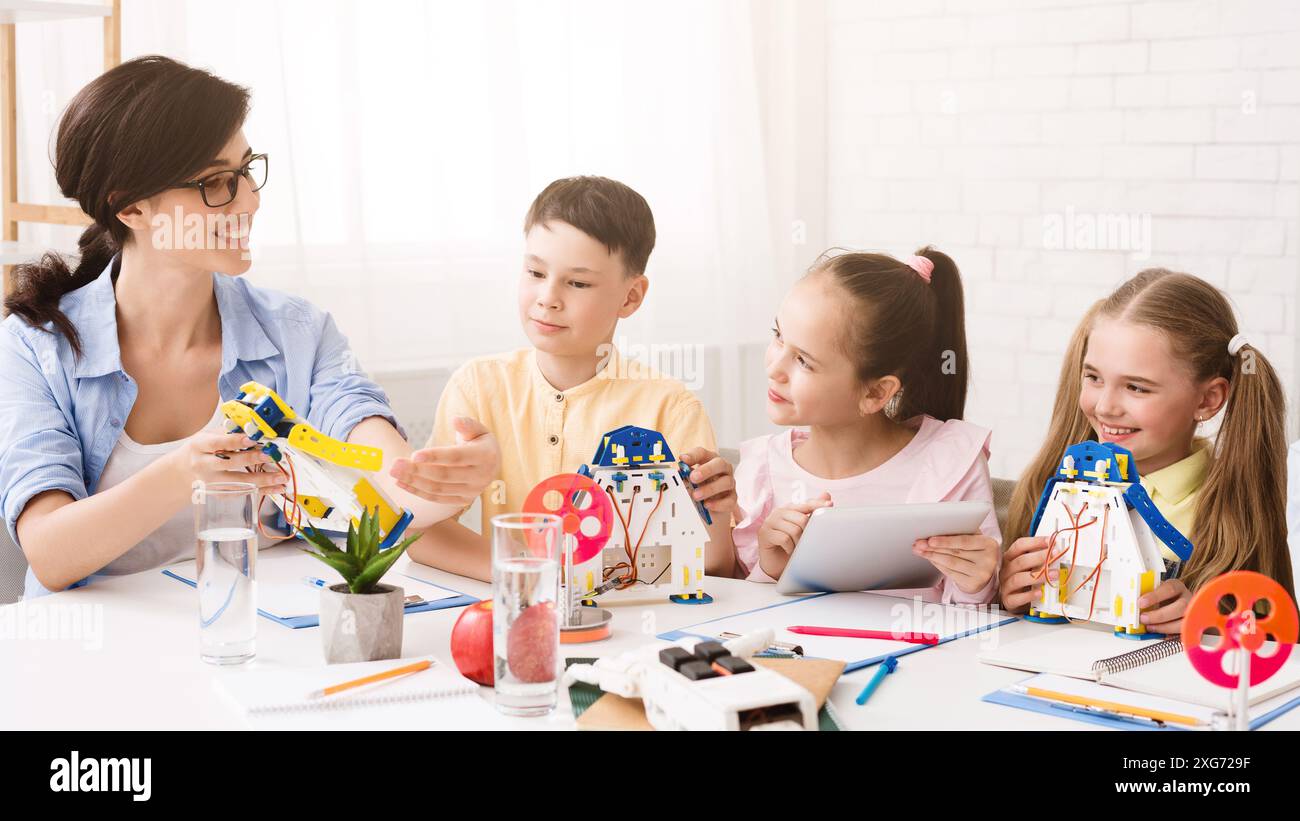 Teacher Showing Students How To Build a Model Robot Stock Photo - Alamy