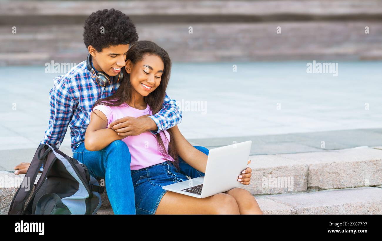 Teen African American Couple Sitting On Steps Using Laptop Stock Photo ...
