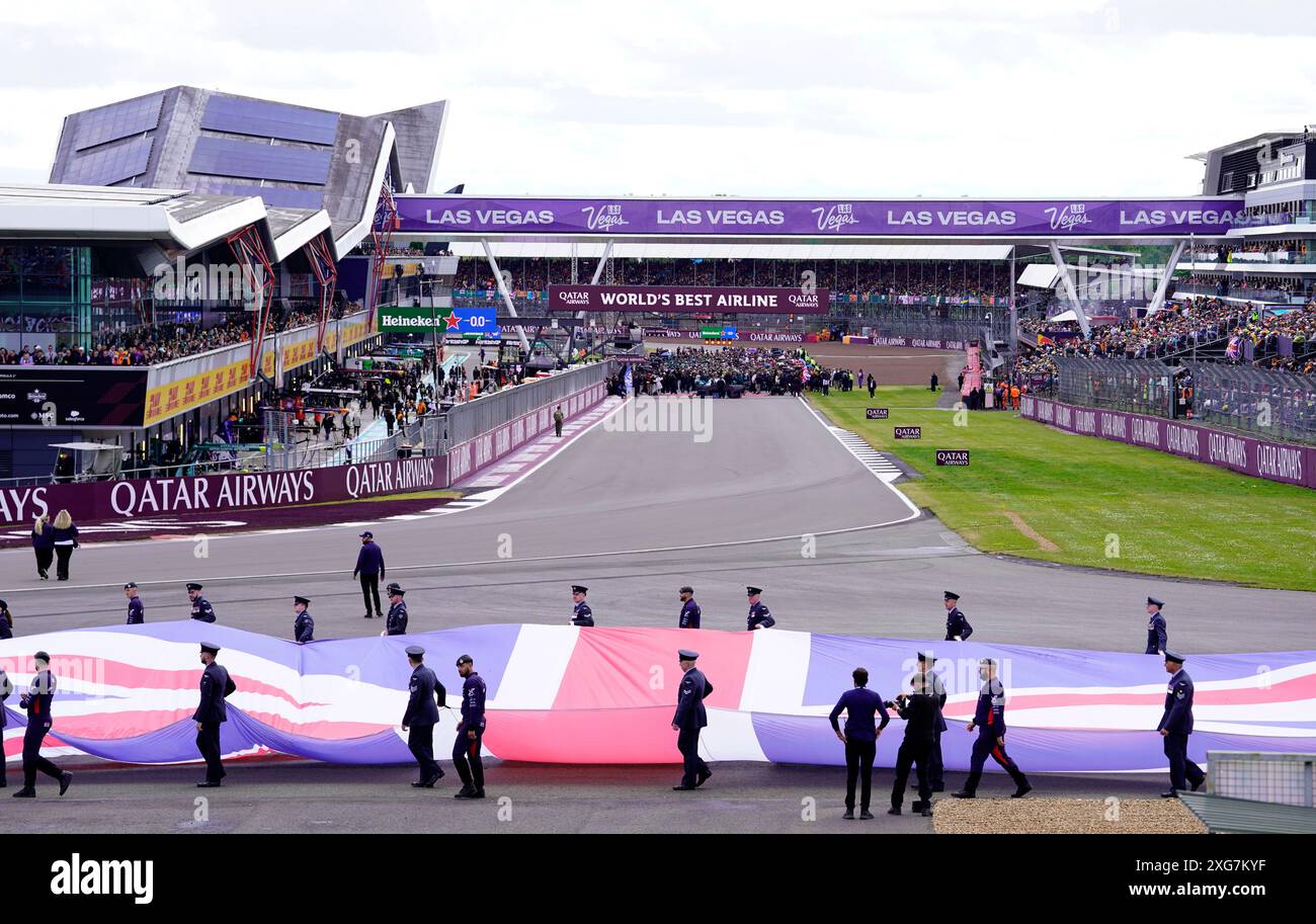 The Union Flag Is Carried Out Onto The Track By Members Of The Armed 