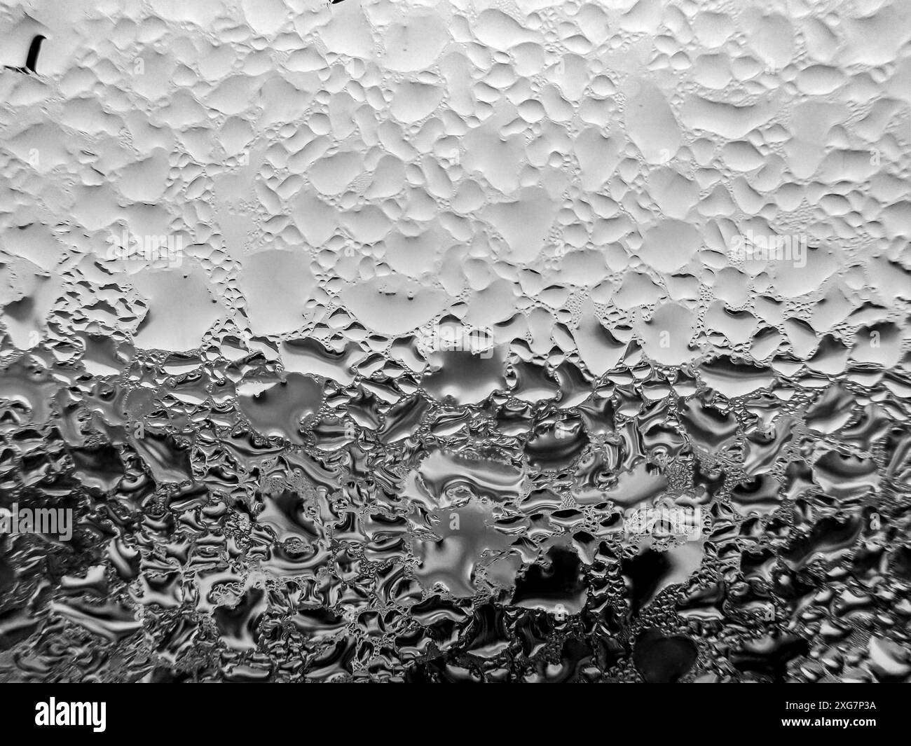 Close up of water droplets on a glass window during the day Stock Photo