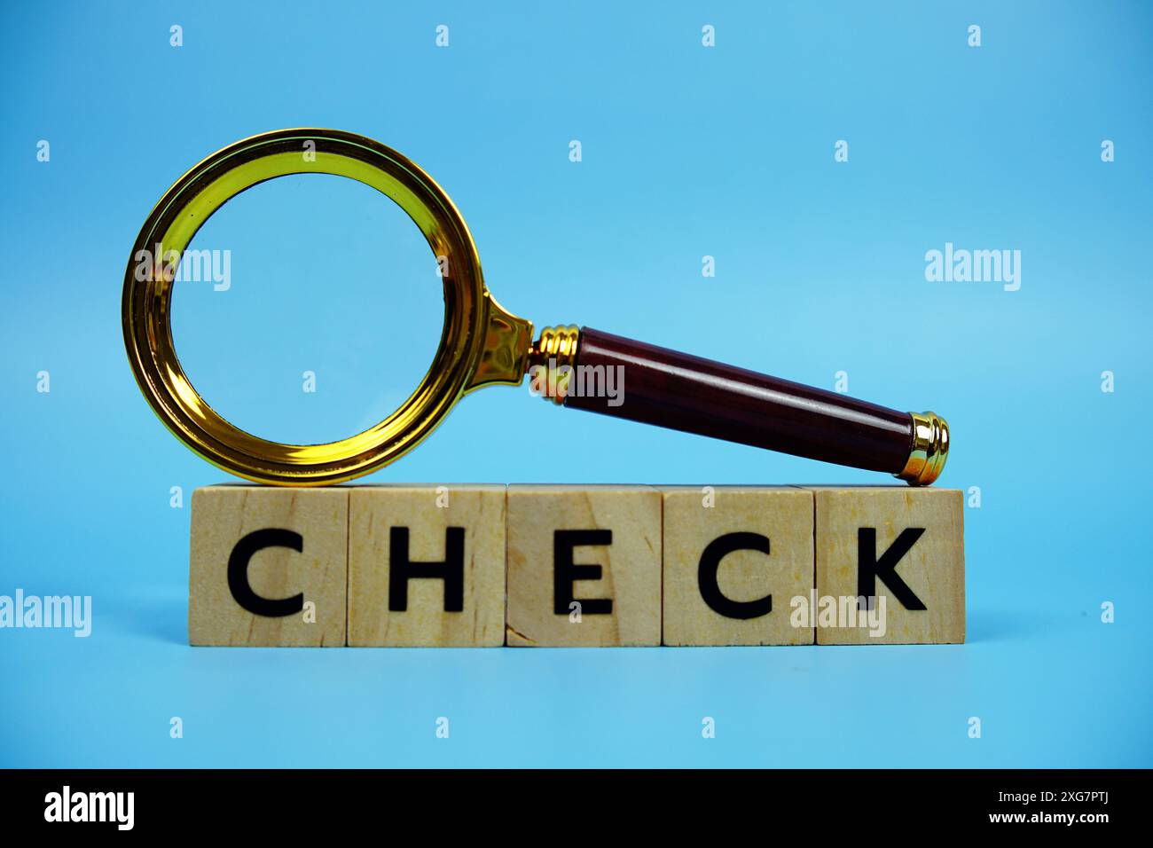 Background Checking Lettering Check with wooden blocks alphabet letters and Magnifying glass on blue ...