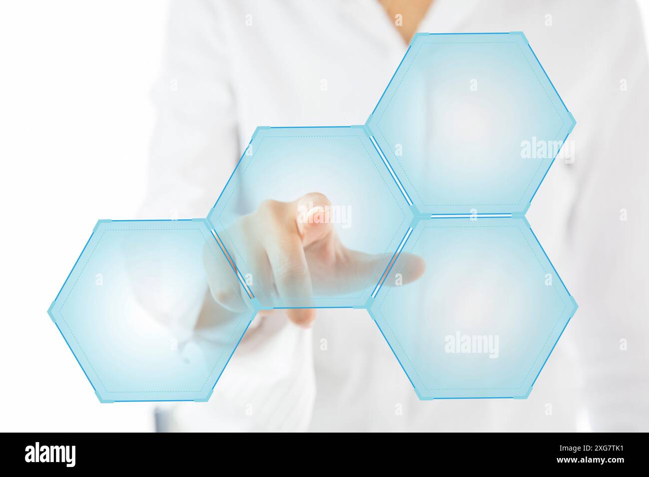 Person touching an hexagonal button on a digital interface Stock Photo