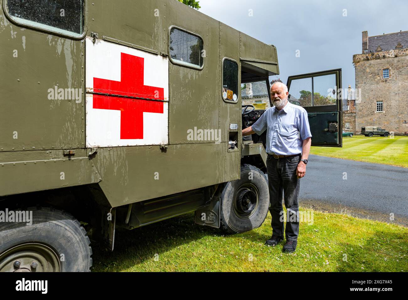 East Lothian, Scotland, UK, 7th July 2024. Wheels of Yesteryear: the Scottish Association of Vehicle Enthusiasts annual jaunt takes owners of vintage vehicles through the countryside to the scenic grounds of Lennoxlove. Pictured: Ron Murdoch shows off his converted 1977 Land Rover Ambulance. Credit: Sally Anderson/Alamy Live News Stock Photo