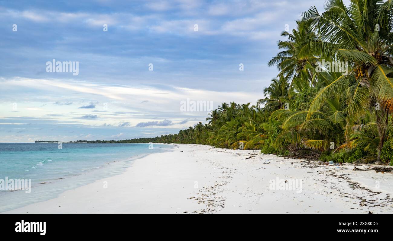 A beach on a desert island in Maldives at sunset Stock Photo