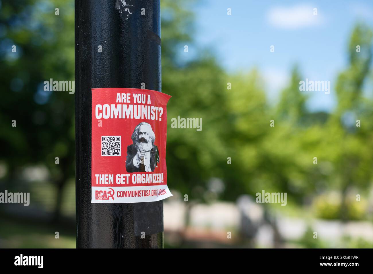 Are You a Communist? advertisement sticker on a lamp post in Flint Michigan USA Stock Photo