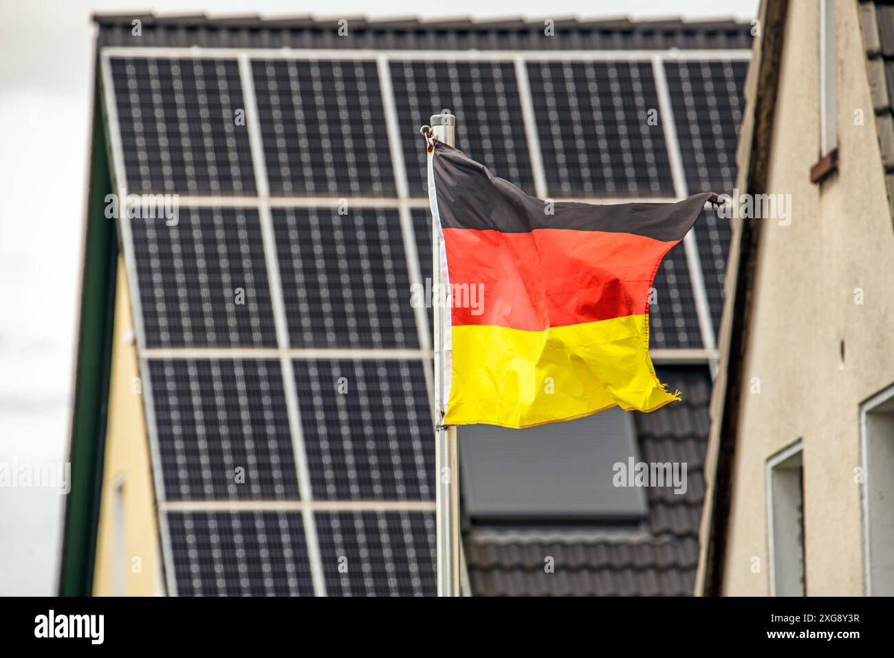 Deutschlandflagge im Wind, Solarmodule auf einem Hausdach, Wickede