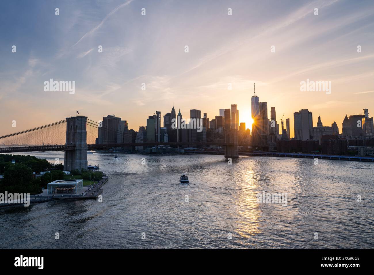 Brooklyn Bridge and New York skyline across the East River under an ...