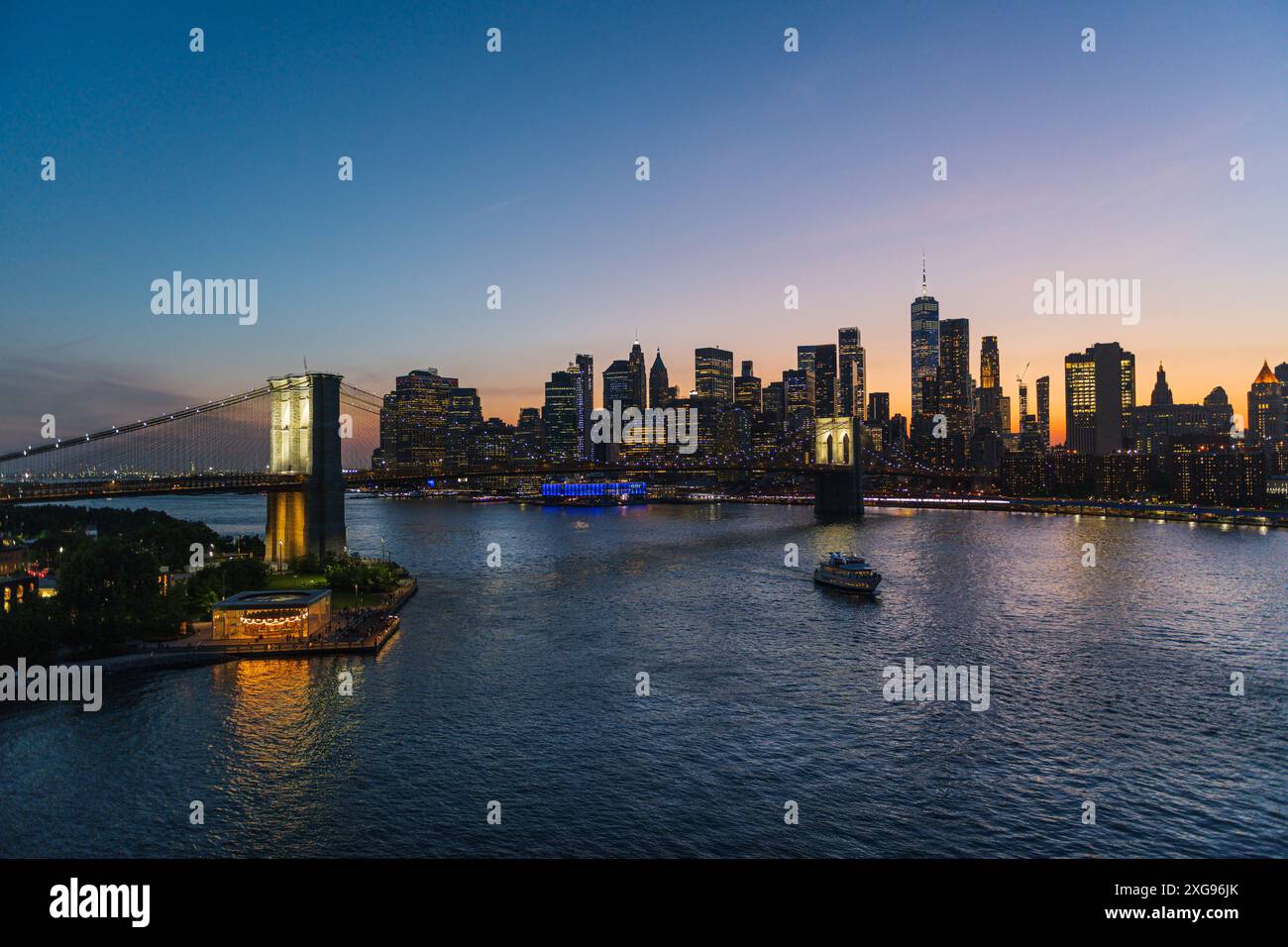 Brooklyn Bridge and New York skyline across the East River under an ...