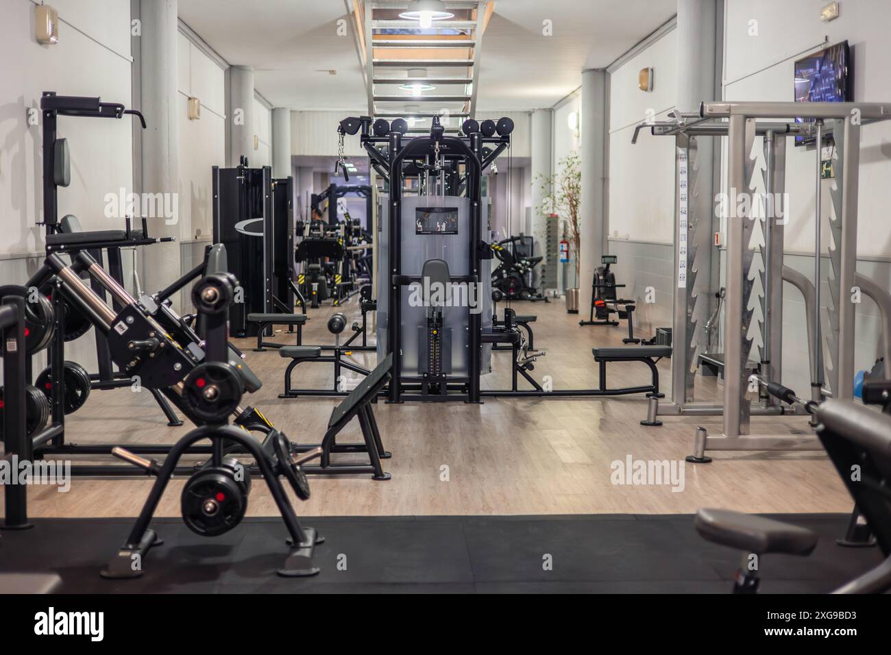 Wide-angle view of a gym interior showcasing a variety of machines ...