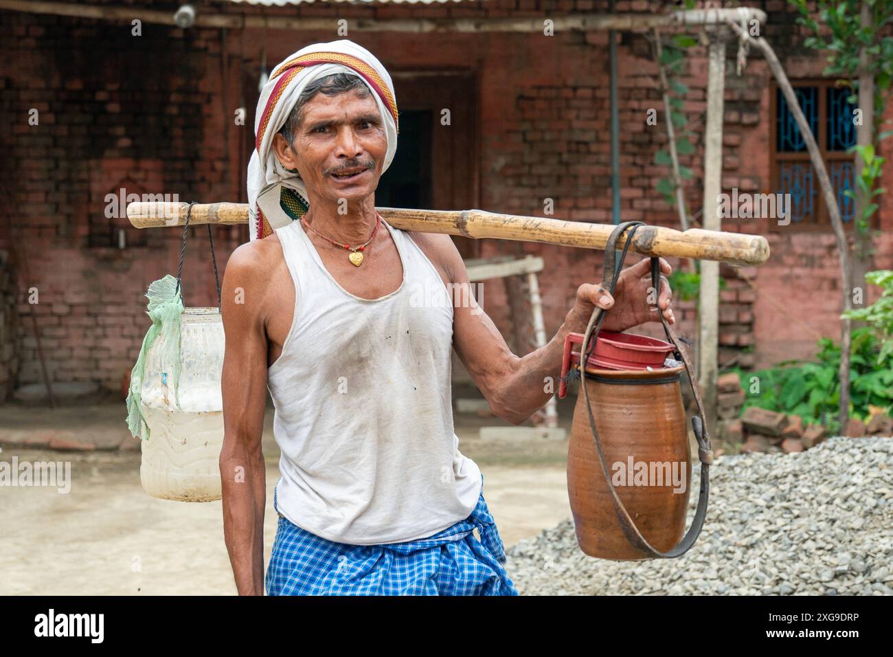 Gopalganj, Bihar, India. 29th June, 2024. A man from the Pasi community (a Dalit, or untouchable, community of India) is going for toddy tapping (palm wine) with his tools. Toddy is a traditional alcoholic drink made from the sap of palm trees. (Credit Image: © Pradeep Gaur/SOPA Images via ZUMA Press Wire) EDITORIAL USAGE ONLY! Not for Commercial USAGE! Stock Photo