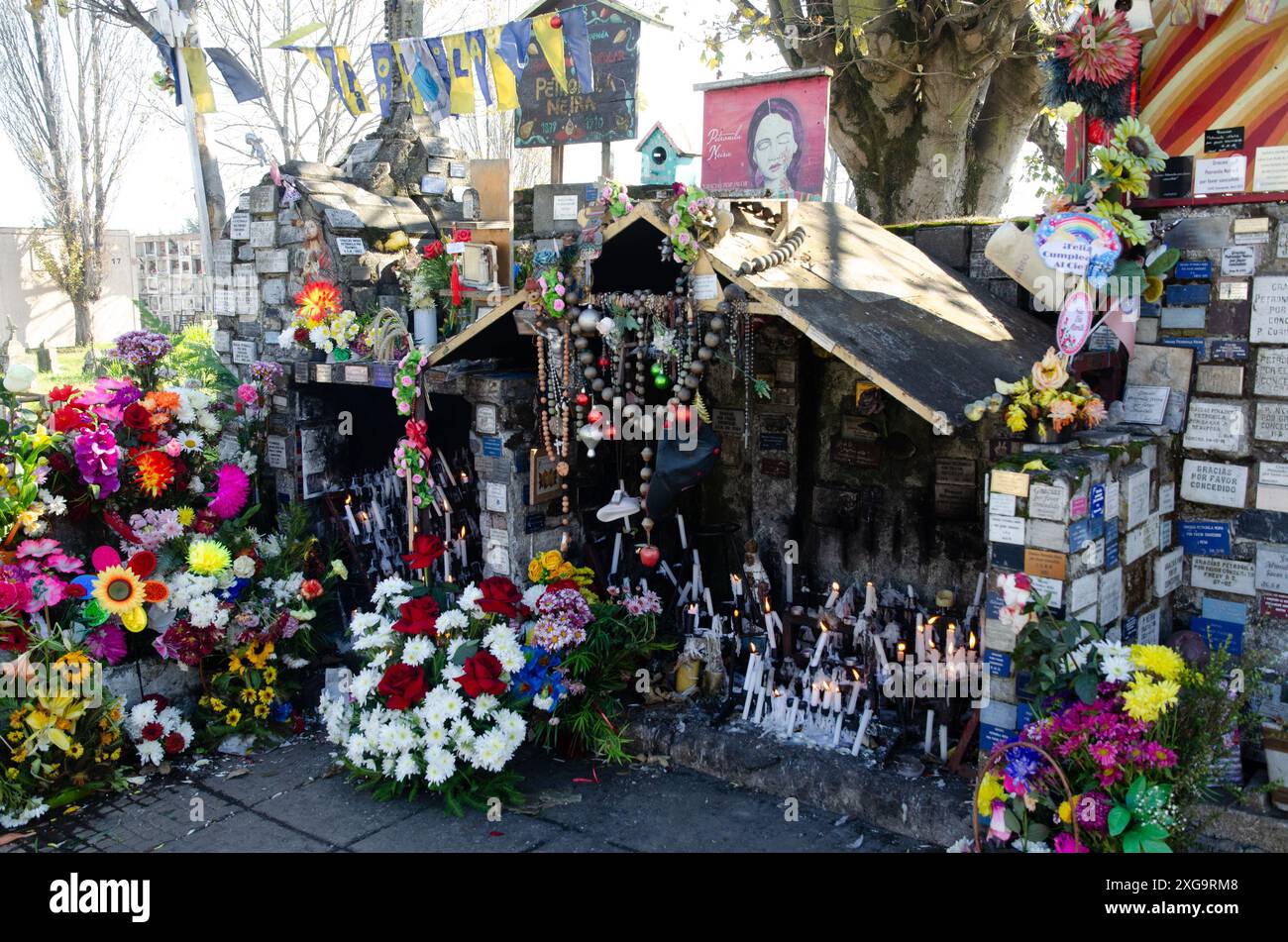 Diverse kinds of offerings around the tomb of Petronila, a popular local saint from Concepcion, Chile Stock Photo