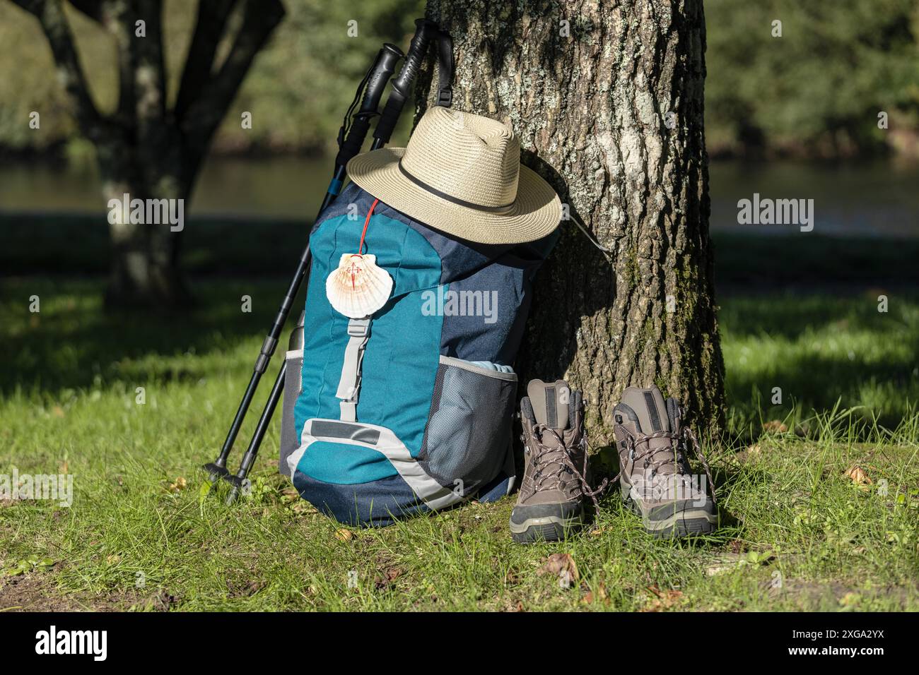 Backpack of a pilgrim leaning against a tree with a hat, trekking boots ...
