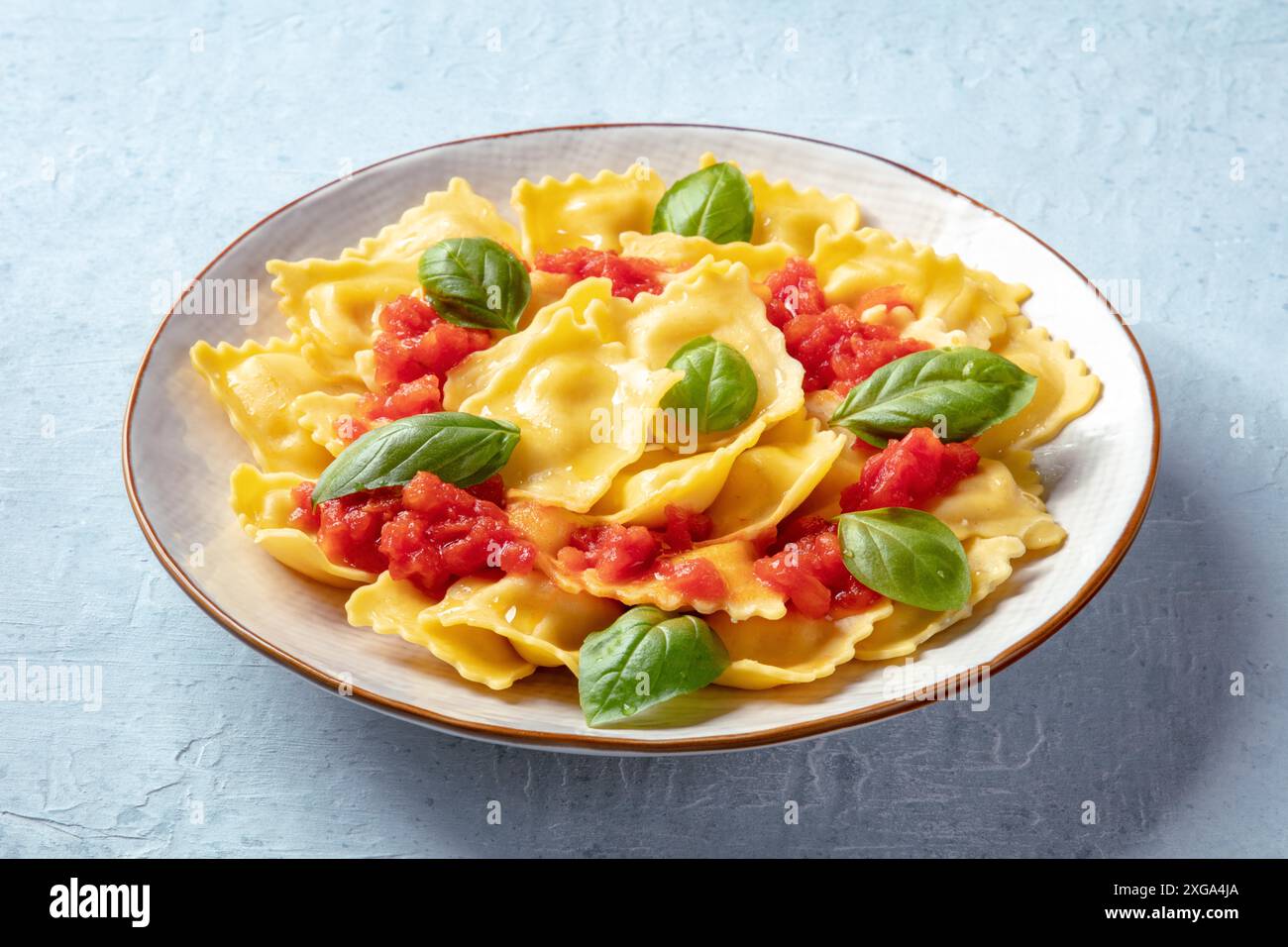 Ravioli with tomato sauce and fresh basil on a plate. Healthy Italian ...