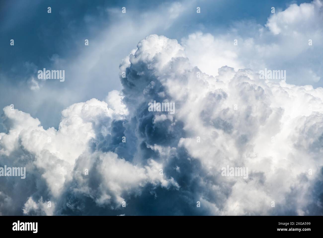 Dramatic sky, light from heaven. (Cumulus) stormy clouds in summer. Background Stock Photo