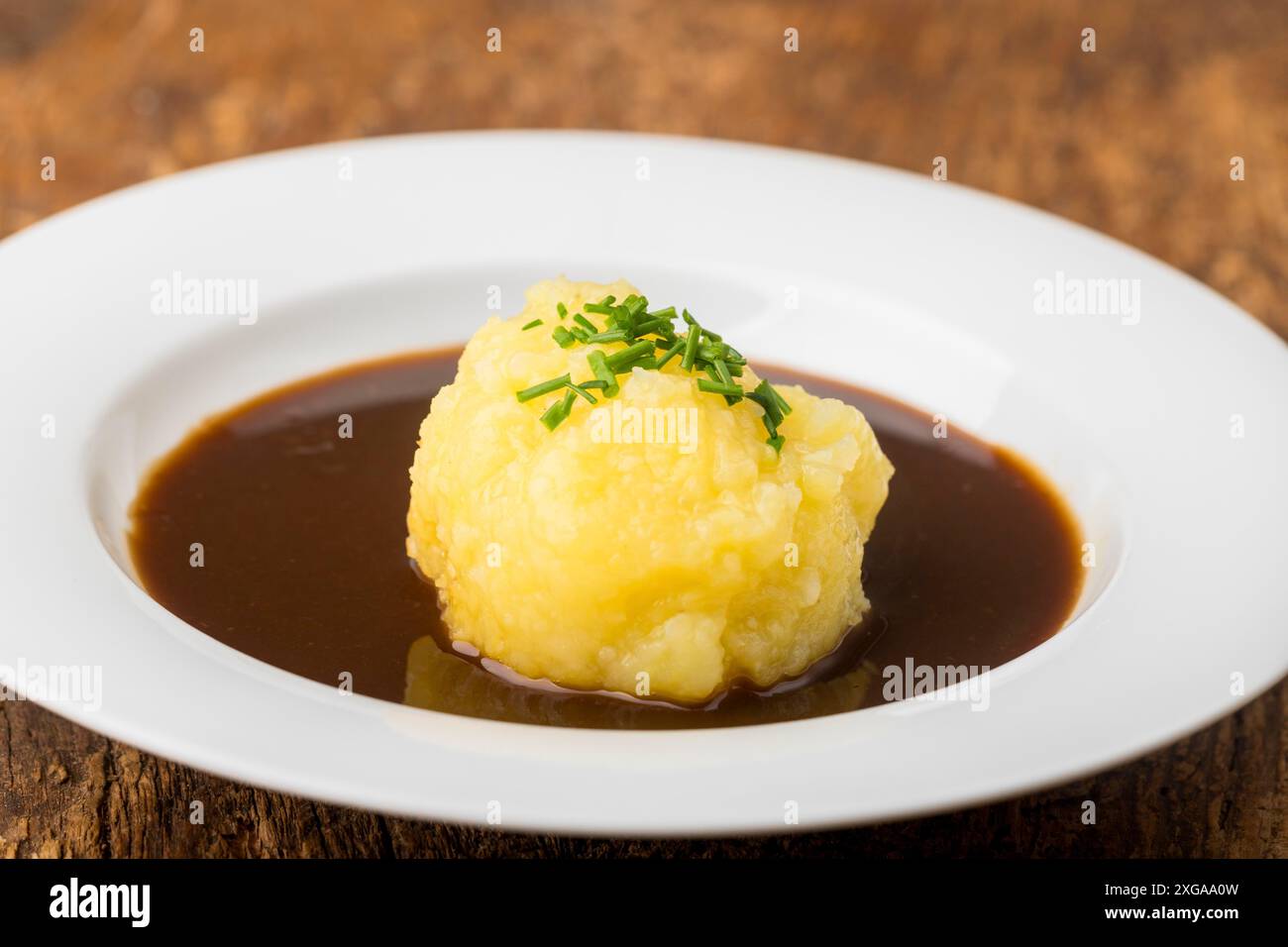 Bavarian dumpling in a plate with sauce Stock Photo