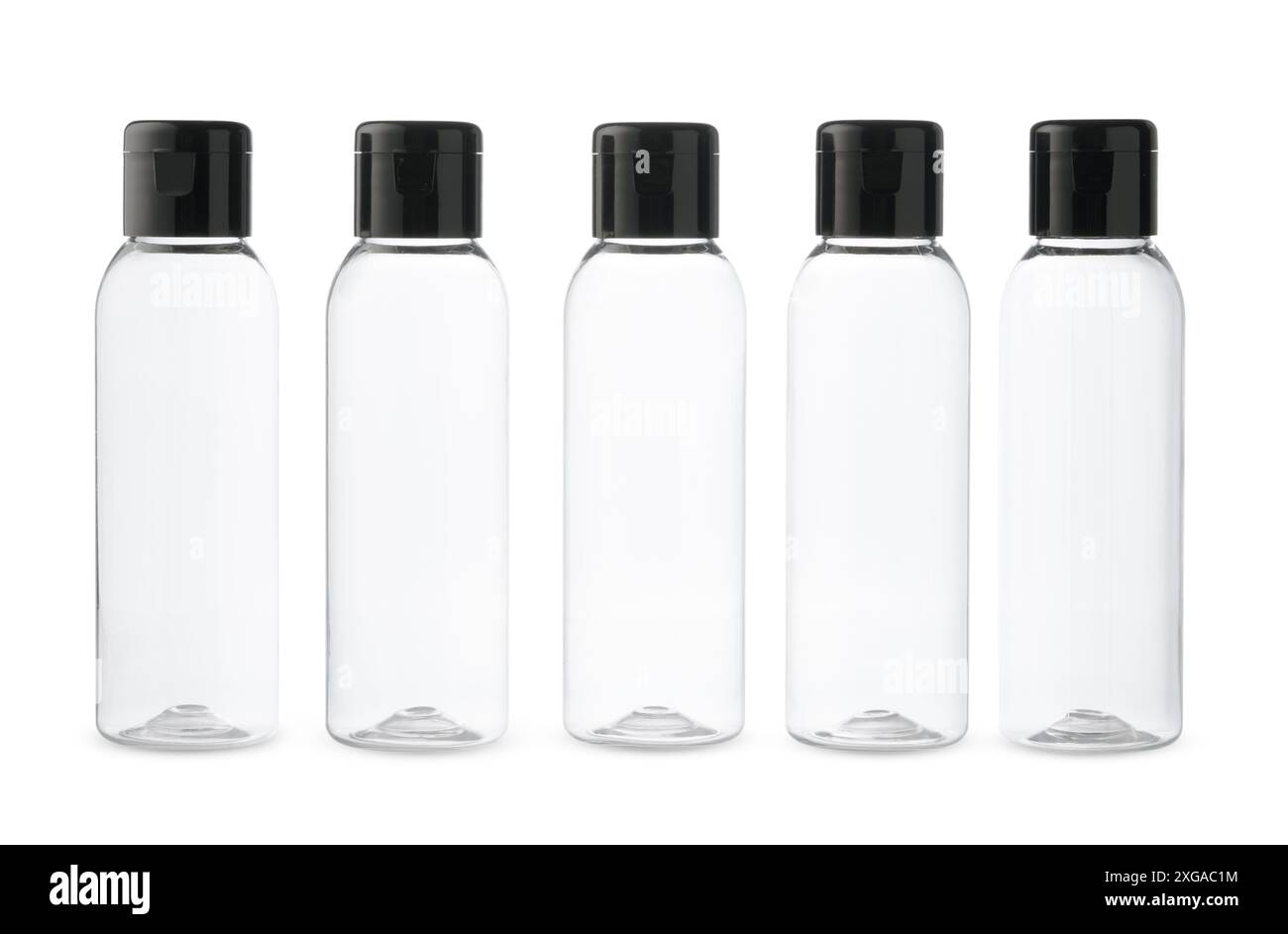 Five Clear Plastic Bottles With Black Caps on a White Background Stock Photo