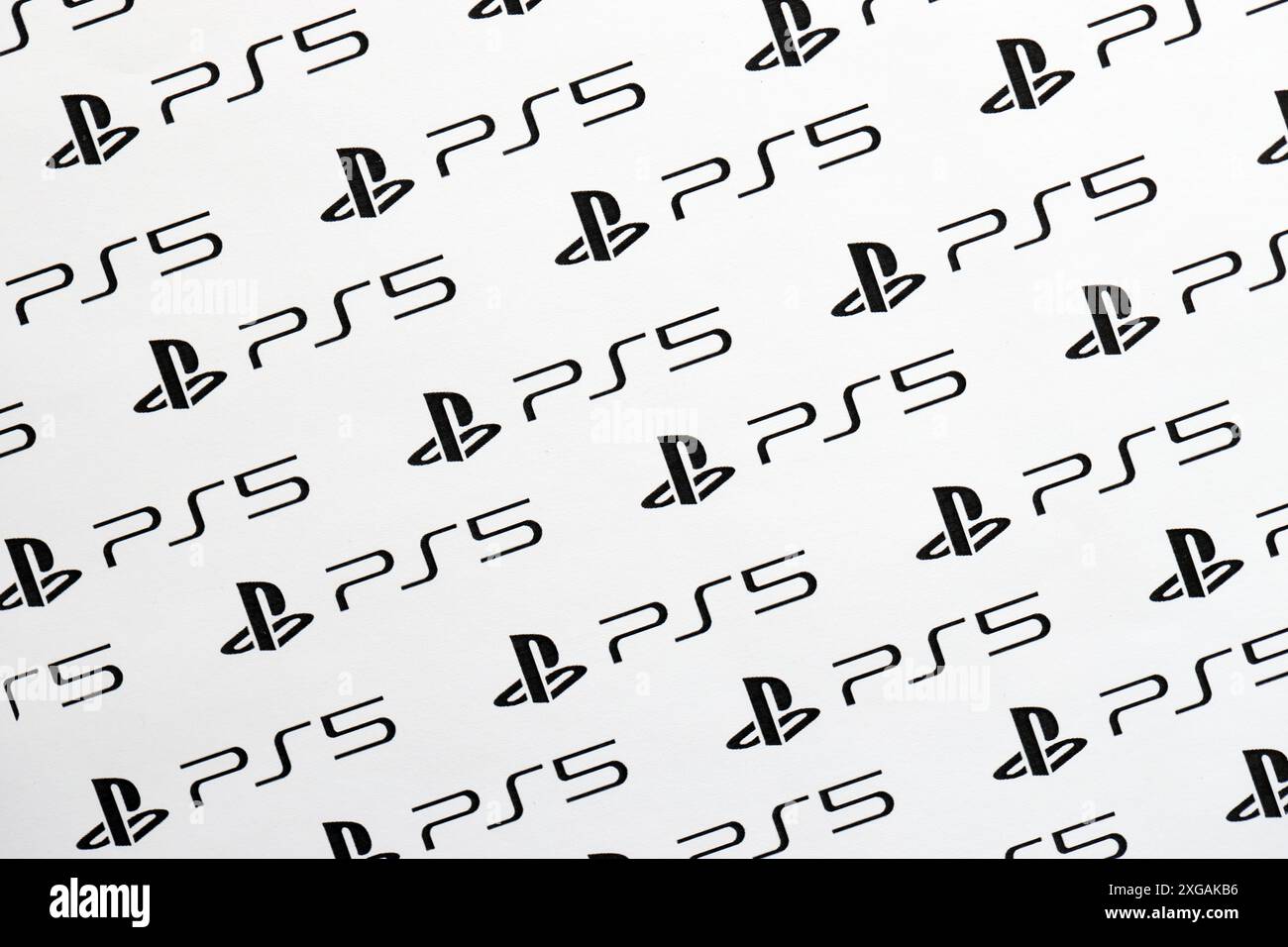 KYIV, UKRAINE - JUNE 26, 2024 Sony Playstation 5 console logo repeating many times on white paper background banner close up Stock Photo