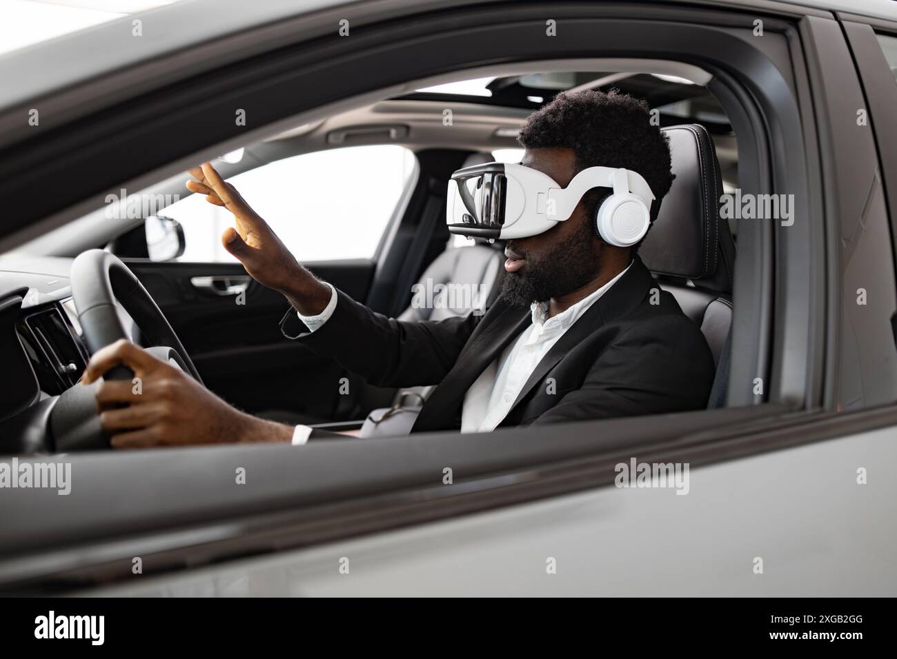 Businessman exploring new car interior using virtual reality headset Stock Photo