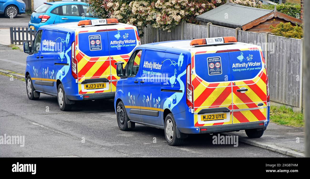 Two of a kind Affinity Water engineers vans parked up in village residential street crews attending to householders supply problems  Essex England UK Stock Photo