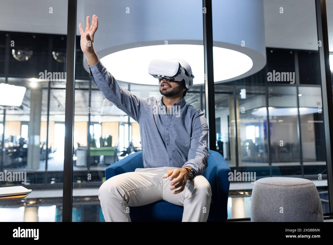 Using VR headset, man interacting with virtual environment in modern ...