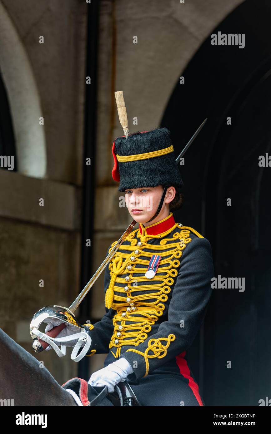 Female soldier of King's Troop Royal Horse Artillery on guard at Horse Guards Parade, Whitehall, London, in dress uniform. Mounted soldier with sword Stock Photo