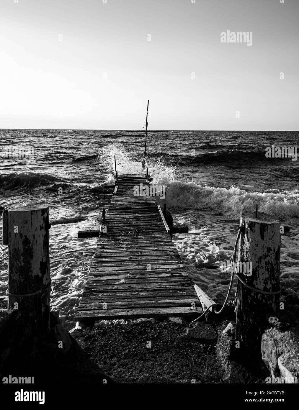 Old wooden bridge into the water Stock Photo