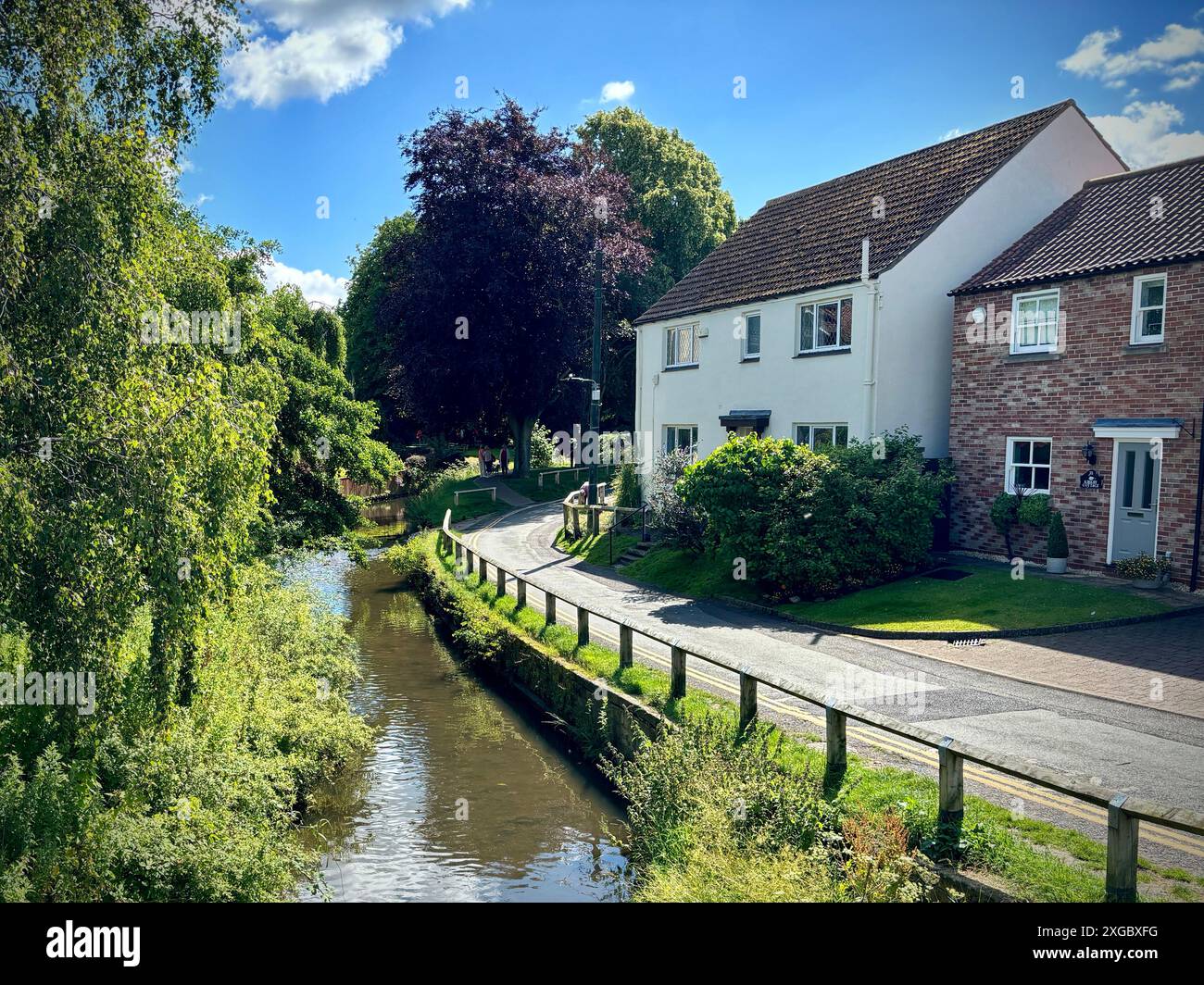 Stokesley, North Yorkshire, UK. 08 Jul 2024. Blue skies and high temperatures made for a stunning summer’s day in Stokesley, North Yorkshire today. The River Leven is pictured running through the village. James Hind/Alamy Live News. Stock Photo