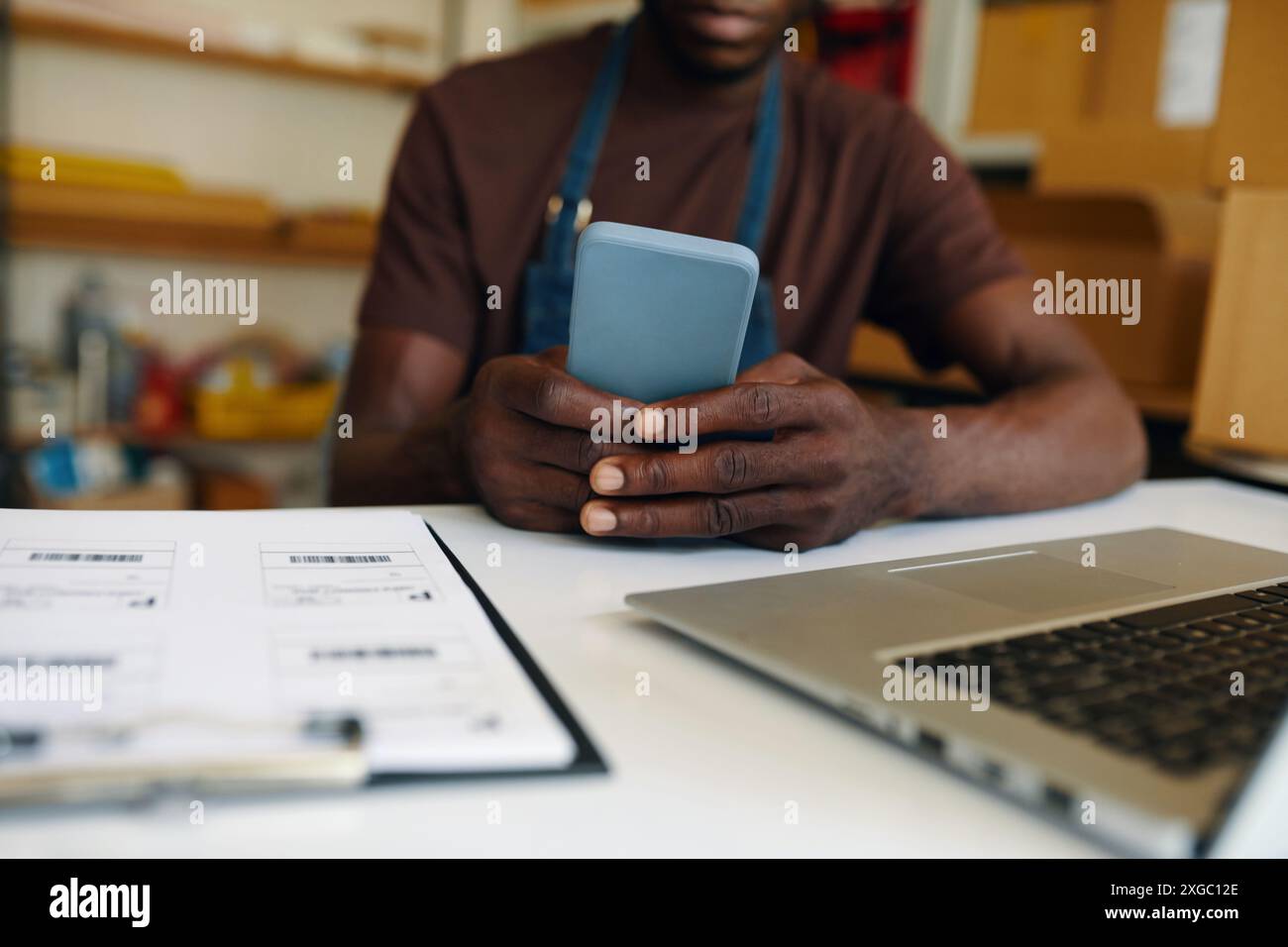 Man Using His Smartphone At Work Stock Photo