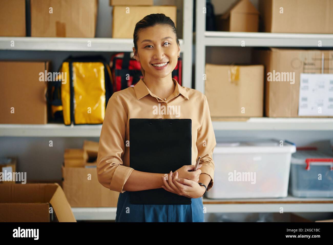 Female Worker Working In Warehouse Stock Photo