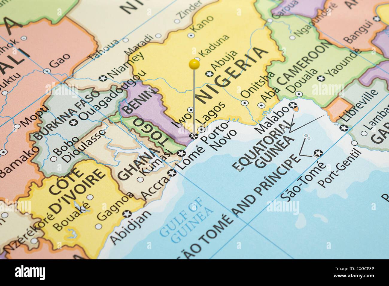 Close up to a Porto Novo city with a yellow pin needle into Benin country political map Stock Photo