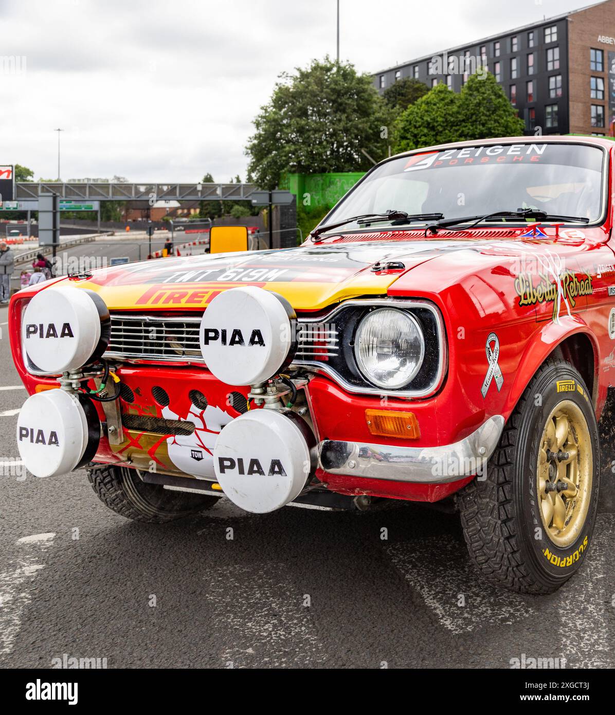 A Ford Escort rally car with full decal parked on the road in an urban environment. Stock Photo