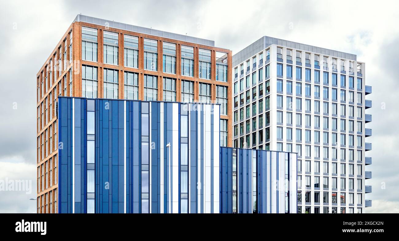 A cluster of modern buildings with strong geometric lines. Contemporary architecture providing a minimalistic aesthetic in an urban landscape. Stock Photo