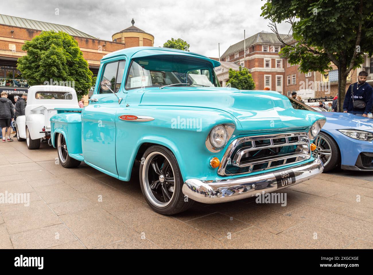 A 1950s Chevrolet 3100 pickup truck in a 3/4 view, showcasing its iconic grille, rounded fenders, and vintage charm under natural sunlight. Stock Photo