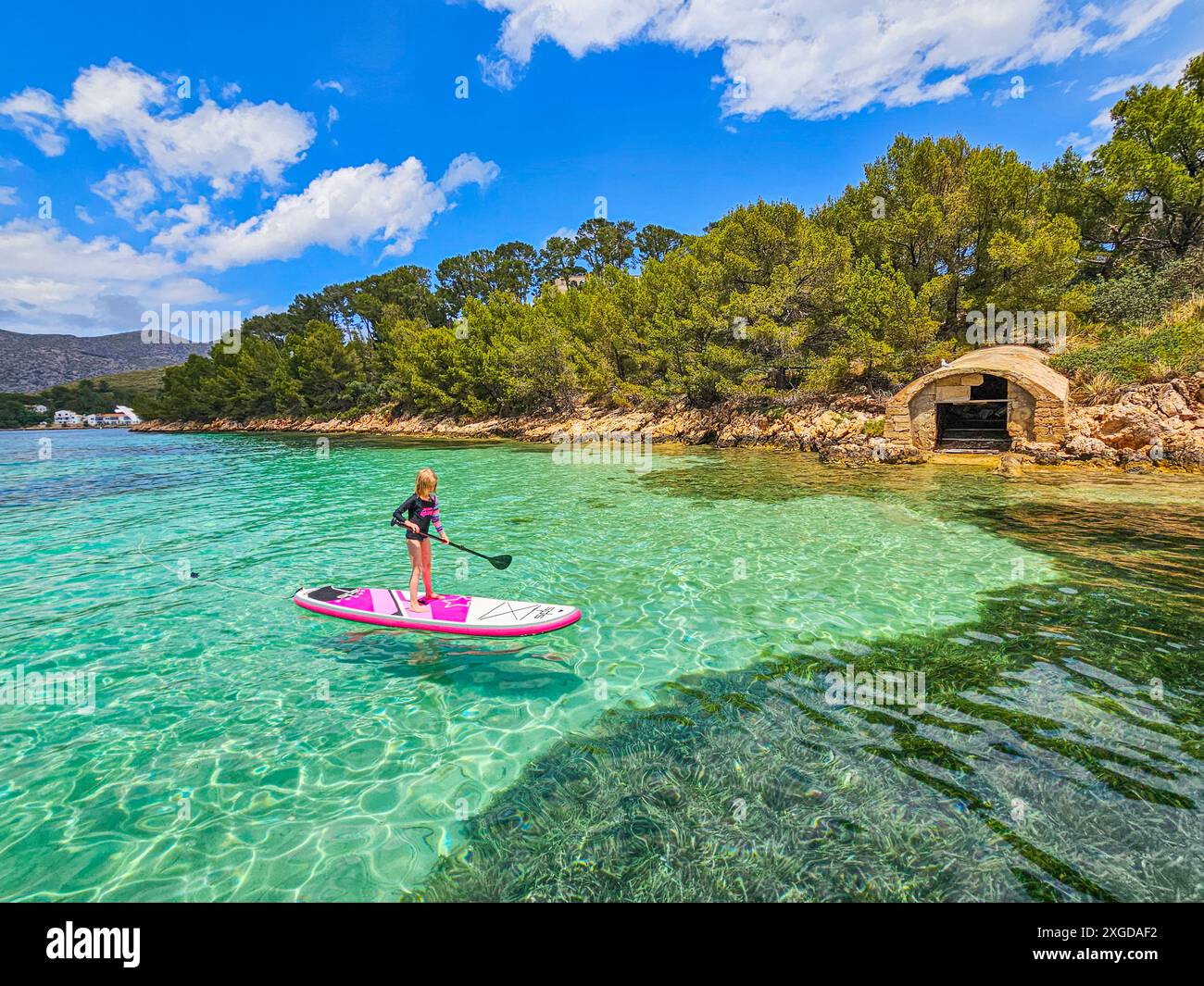 Girl on a SUP in the turquoise waters of the Formentor Peninsula, Mallorca, Balearic islands, Spain, Mediterranean, Europe Stock Photo