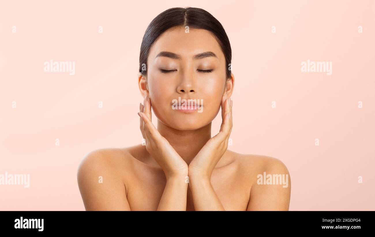 Young Woman With Closed Eyes Touching Her Face Stock Photo - Alamy