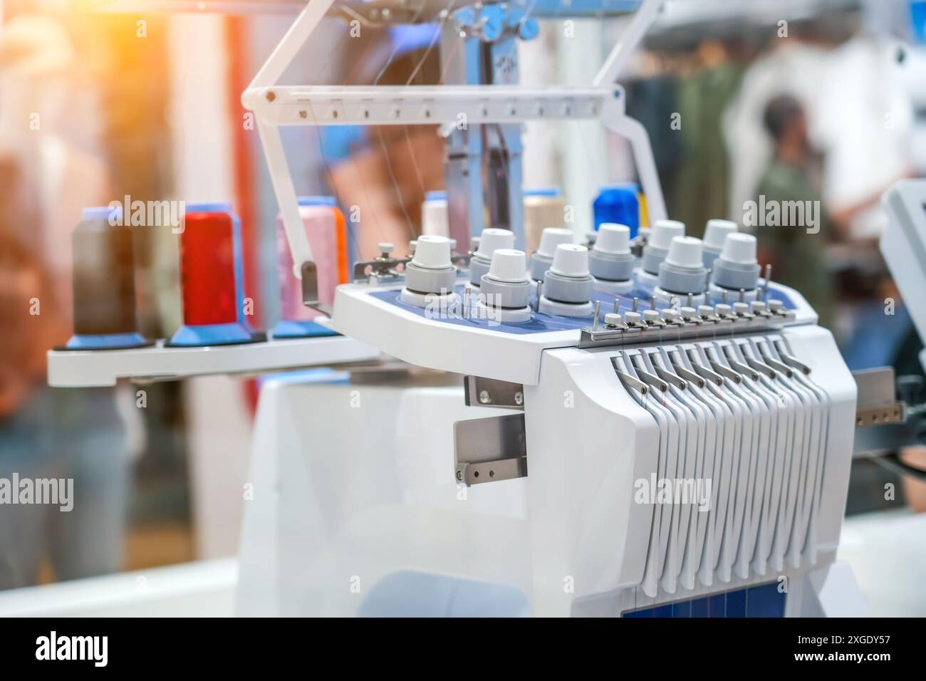 Threads on a sewing machine in loops from spools during automatic operation Stock Photo