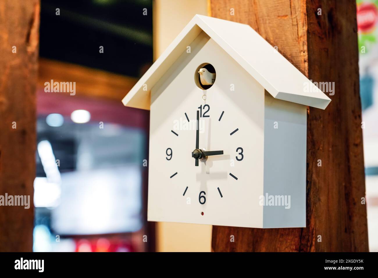 White Cuckoo clock on a wooden pillar support wall Stock Photo