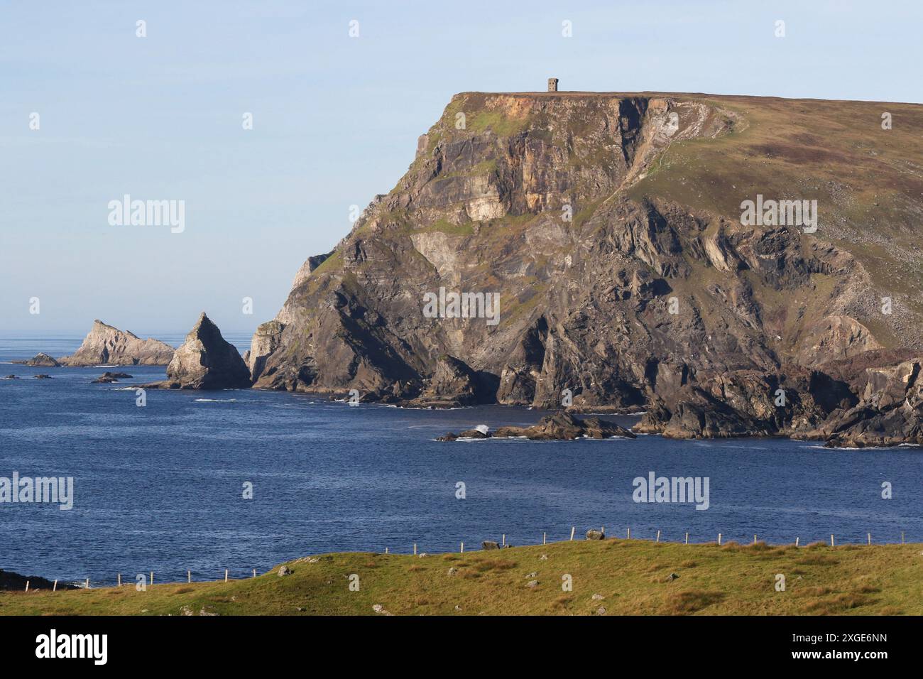 Sea cliffs Donegal rugged coastline of Ireland in Gaeltacht area Glen Head and Napoleonic signal tower County Donegal Ireland. Stock Photo