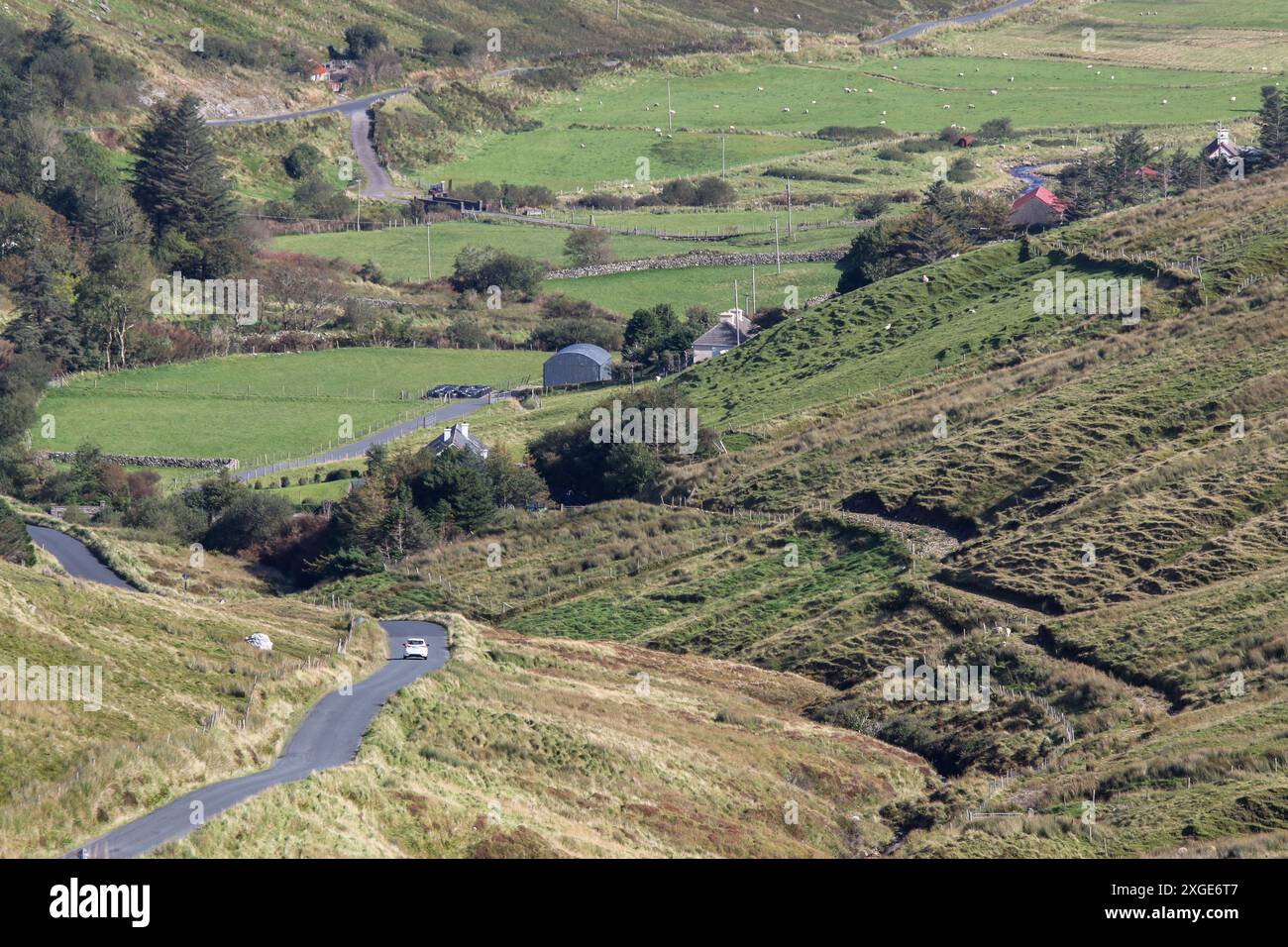 White car winding rural country road  County Donegal Ireland - Glencolmcille Valley Gaeltacht area region. Stock Photo