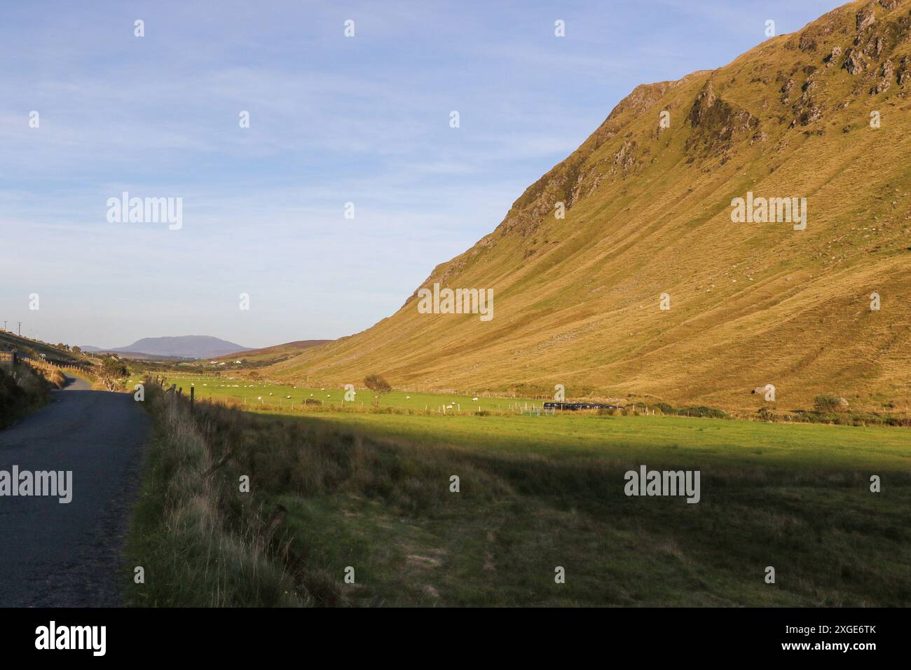 Rural road evening sunshine valley Ireland landscape Gaeltacht Glencolmcille Valley County Donegal. Stock Photo