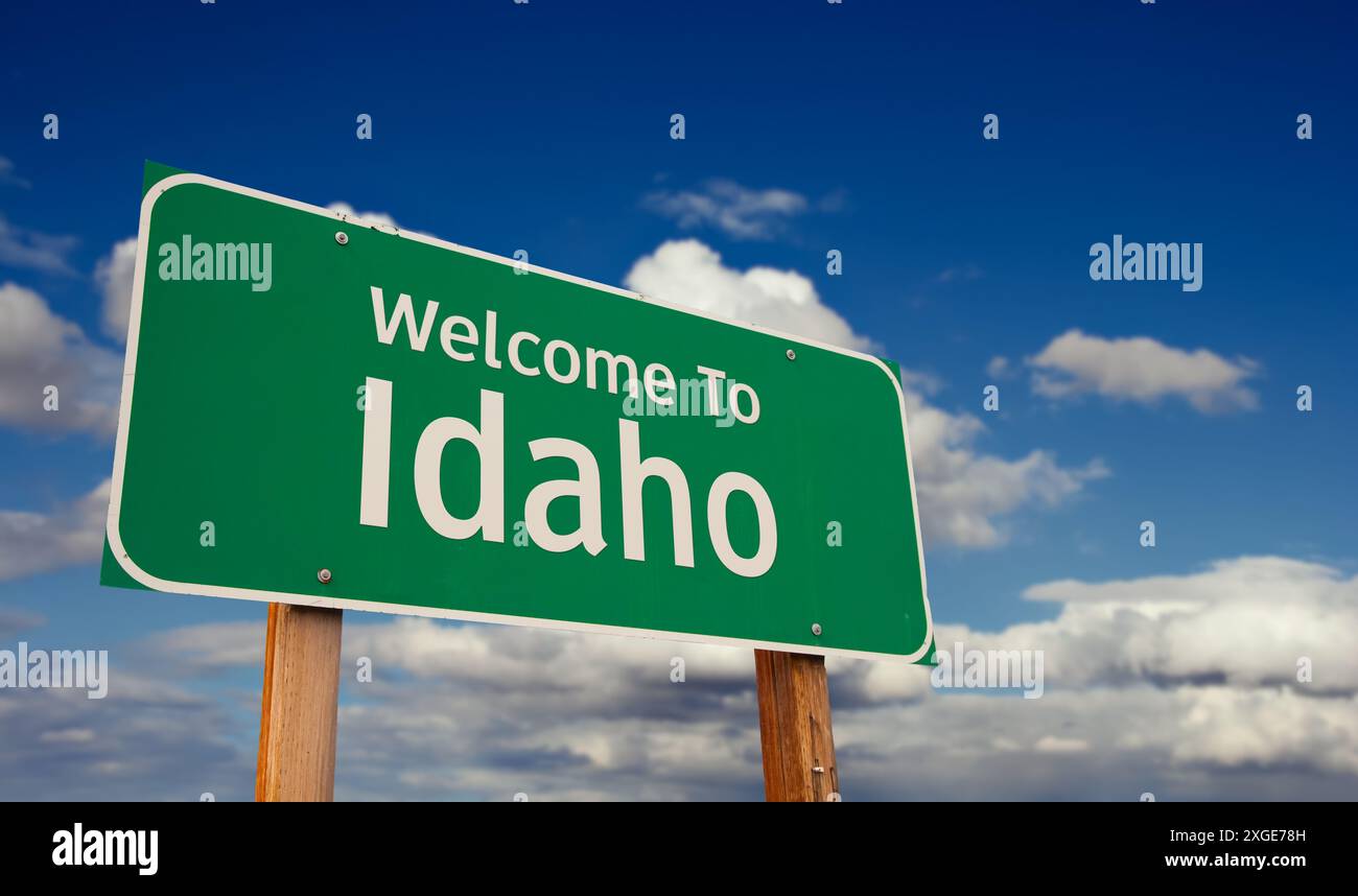 Welcome To Idaho Green Road Sign Over Blue Sky with Some Clouds. Stock Photo