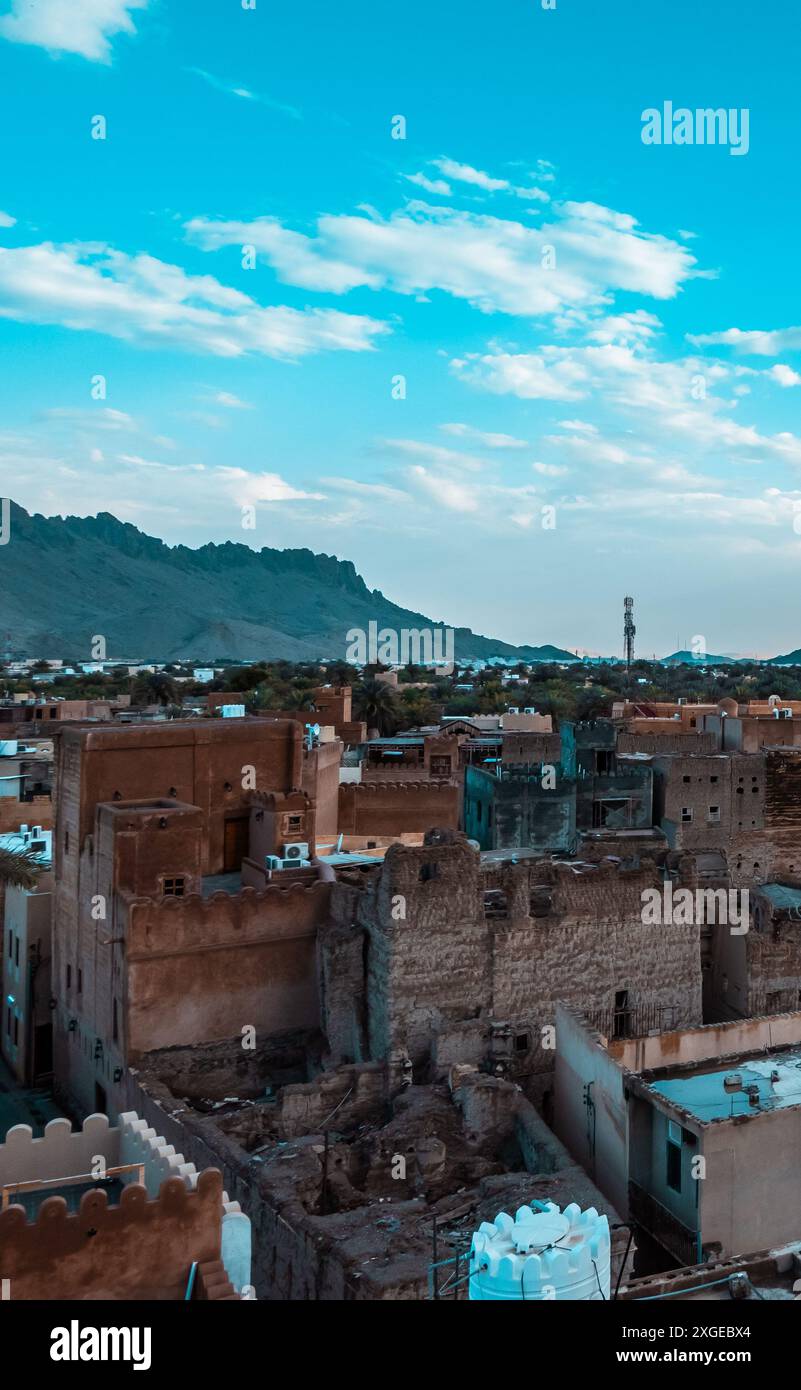 Beautiful sunset view of the old city of Nizwa, Oman with historic ruins and buildings including Nizwa Fort Stock Photo