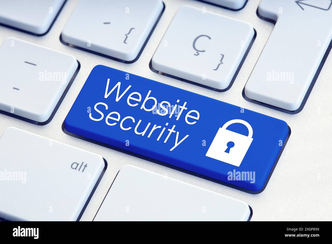 Website Security word and padlock icon on blue computer keyboard Stock Photo