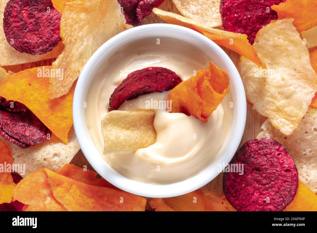 Vegetable chips with a dip close-up shot, top view Stock Photo