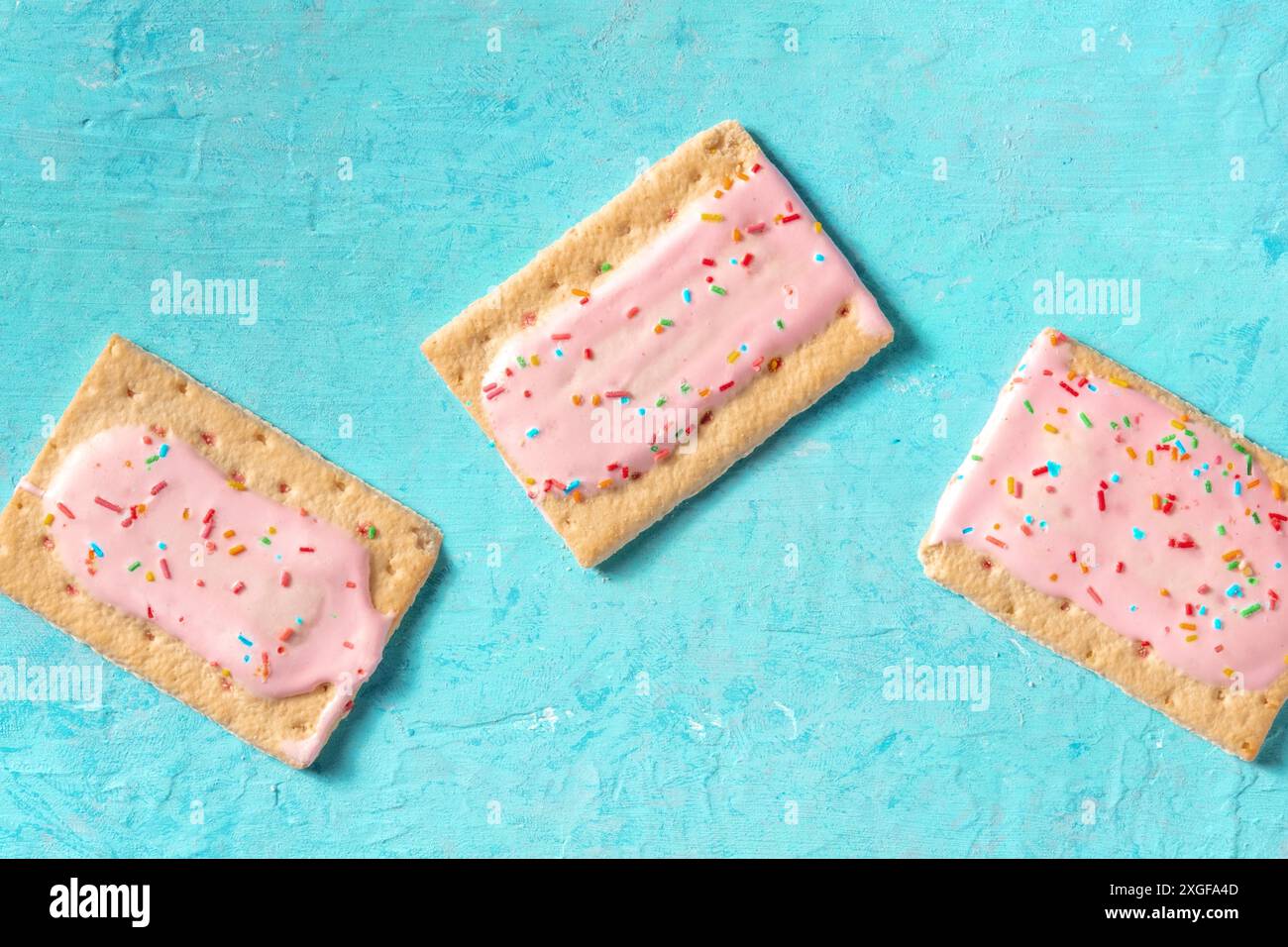 Pink pop tarts on a blue background, top shot of toaster pastry Stock ...