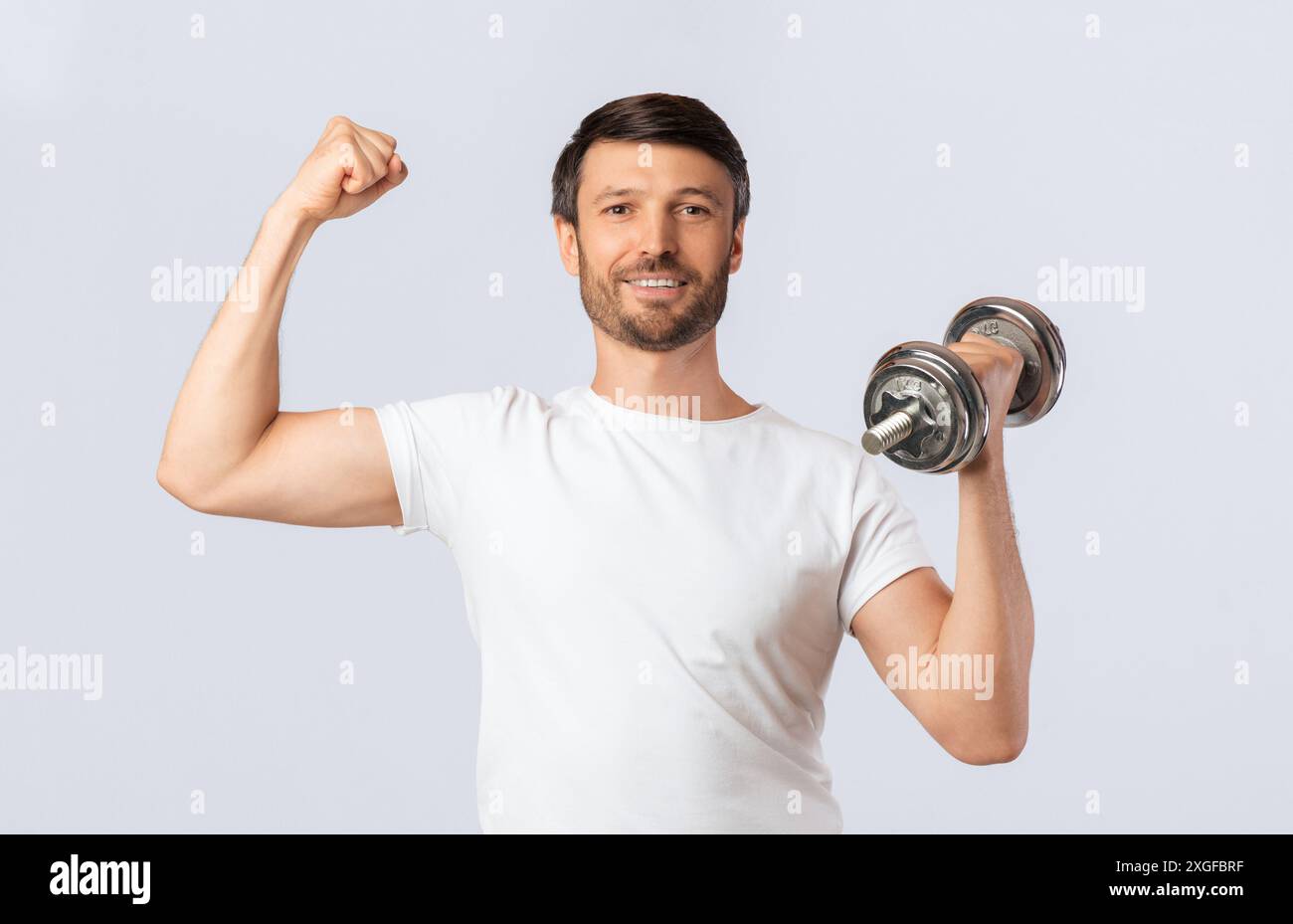 Strong man holding dumbbell hi-res stock photography and images - Alamy