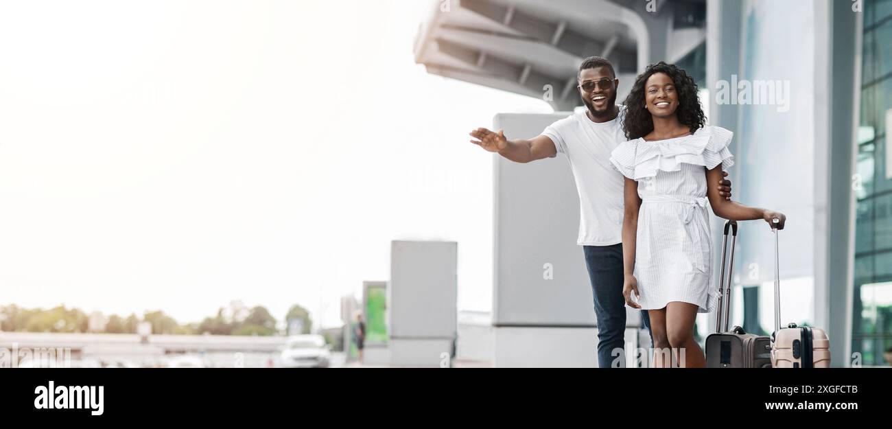 Happy Black Couple Arriving at Airport With Luggage Stock Photo - Alamy